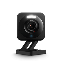 A black security camera on a stand.