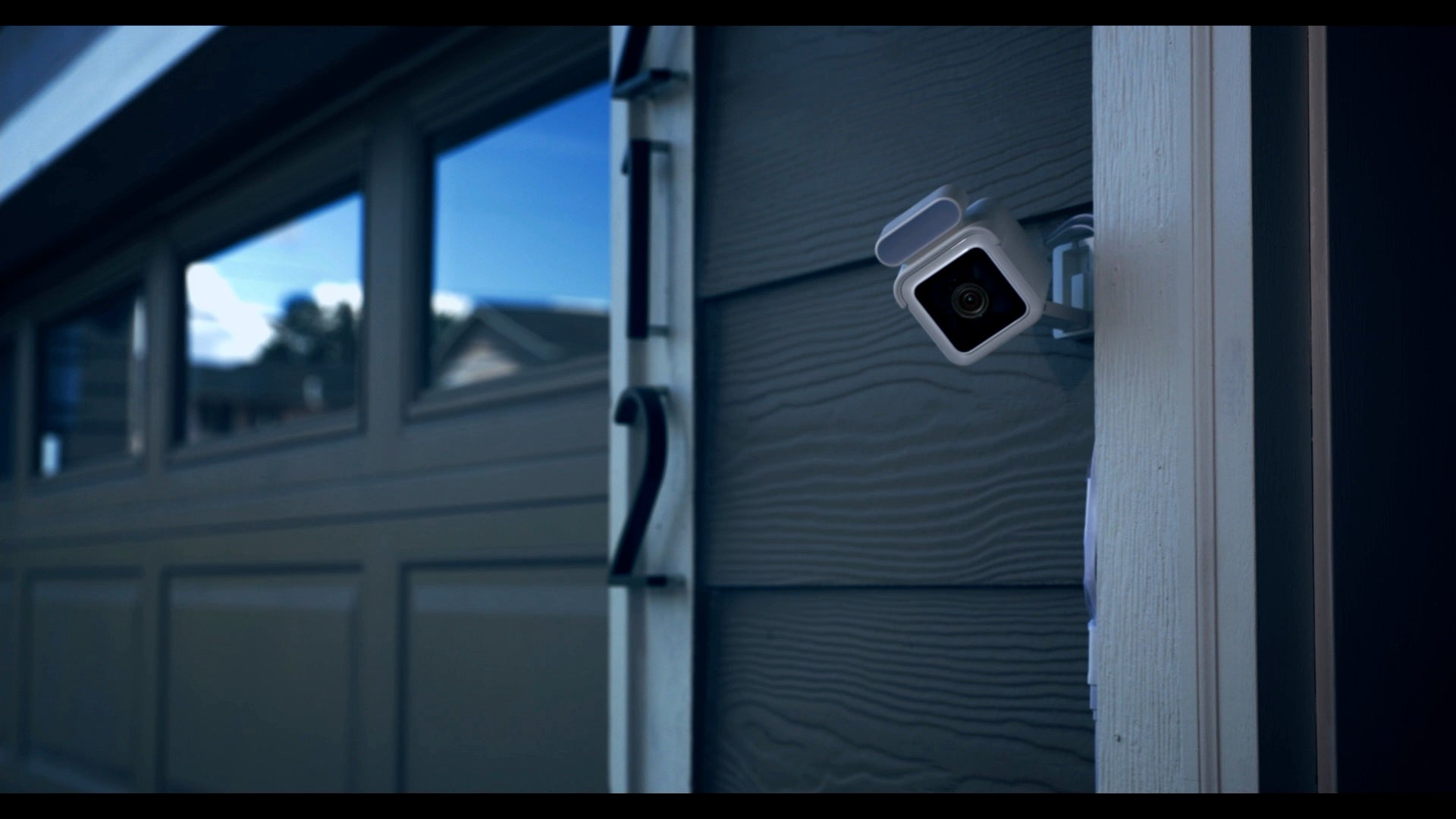 A wyze camv3 spotlight sc is attached to a house.