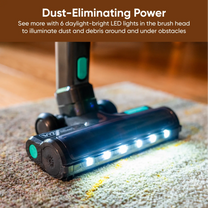 A cordless vacuum cleaner with a bright light on the front.