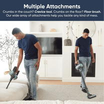 A man is holding a cordless vacuum cleaner.