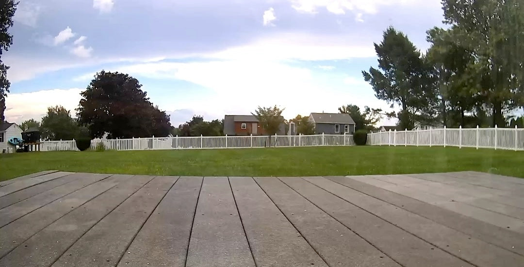 Load video: Pan camera tracking a squirrel moving across the entire length of the deck.