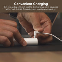A person is holding a Wyze Removable Battery Pack.