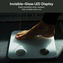 A person standing on a scale with their feet visible.