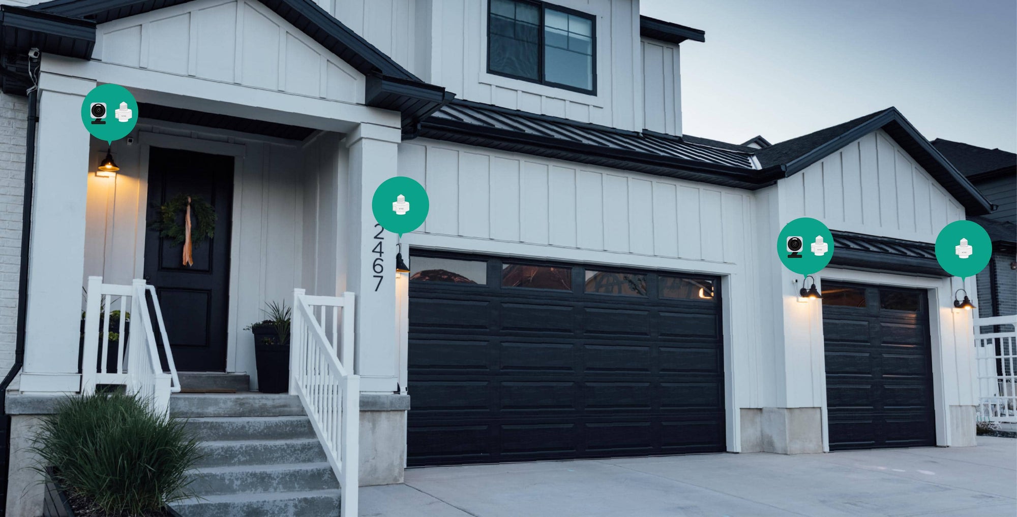 A black garage door with a green box on it.