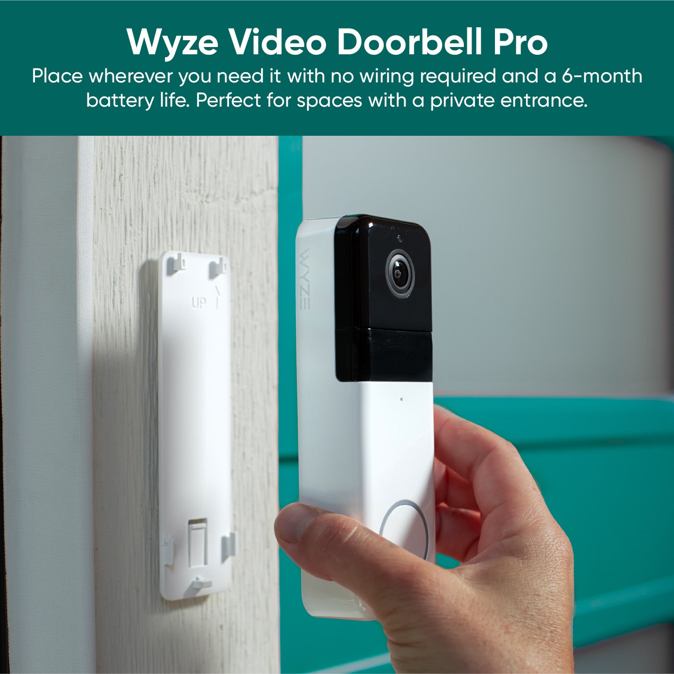 Person installing a Wyze Video Doorbell Pro onto a wall mount plate.