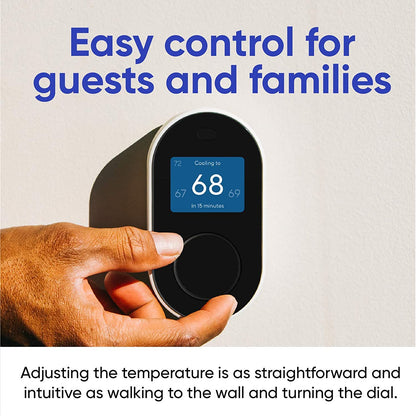 Hand adjusting the Wyze Thermostat unit that is mounted on a wall. Blue text overlay that says "Easy control for guests and families."