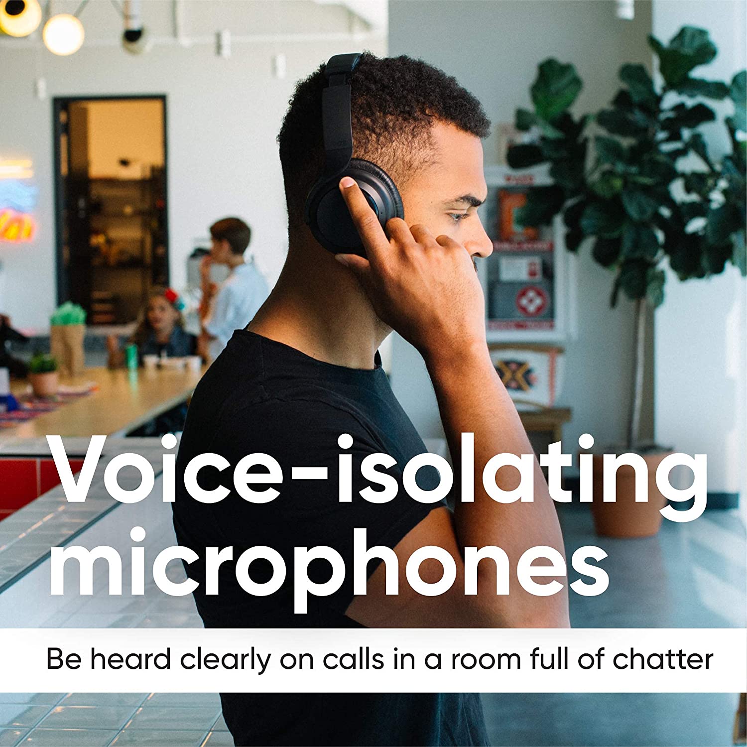 Person wearing noise canceling headphones with kids in the background. Text overlays says, " Voice isolating microphones. Be heard clearly on calls in a room full of chatter."
