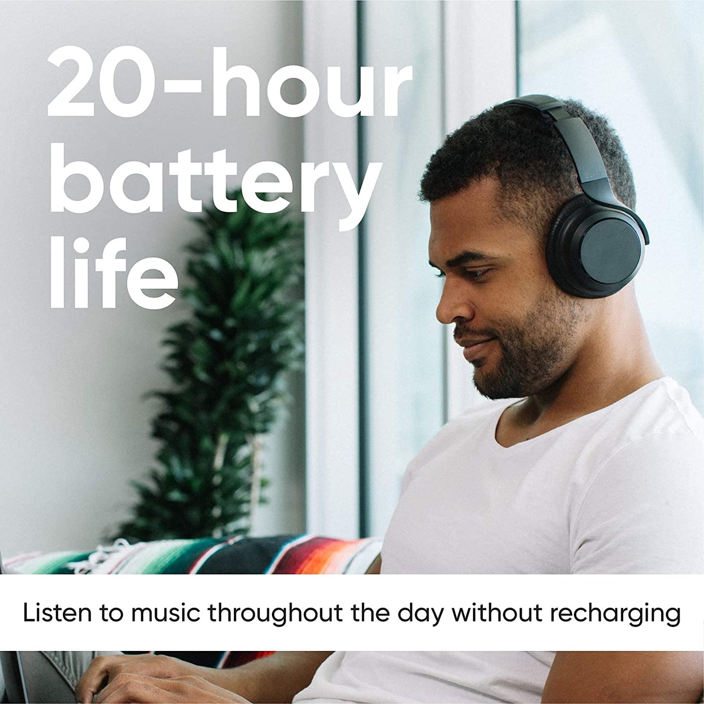 Person wearing noise canceling headphones. Text overlays says, "20 hour battery life."