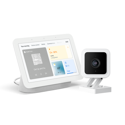 Google Nest Hub next to a Wyze Cam v3 against a white background.