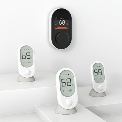 Three Wyze Room Sensors next to a Wyze Thermostat