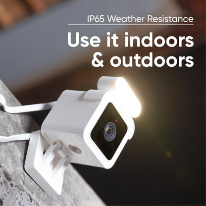 Wyze Cam v3 with Spotlight above, turned on. Text overlay "IP65 Weather Resistance."