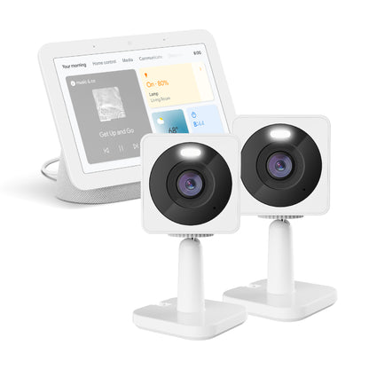 Google Nest Hub next to two Wyze Cam OG Standard against a white background.