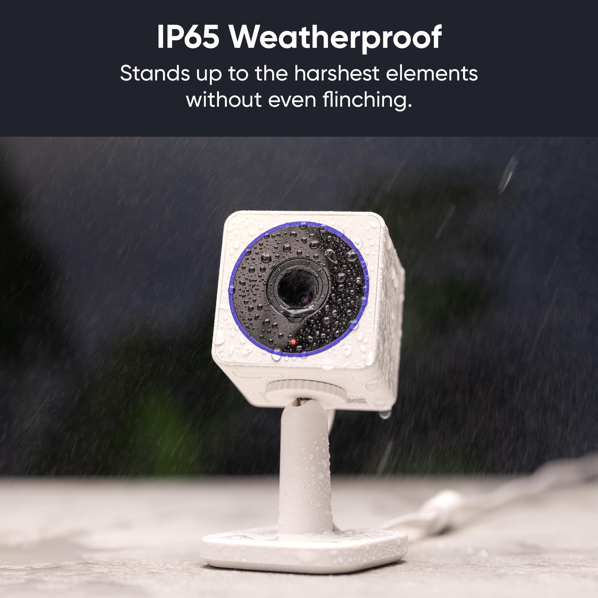 Rain water falling onto a Wyze Cam OG Telephoto. White text overlay that says "IP65 Weatherproof."