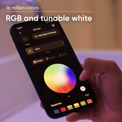 Person holding smartphone with Wyze app open to the bulb color settings.