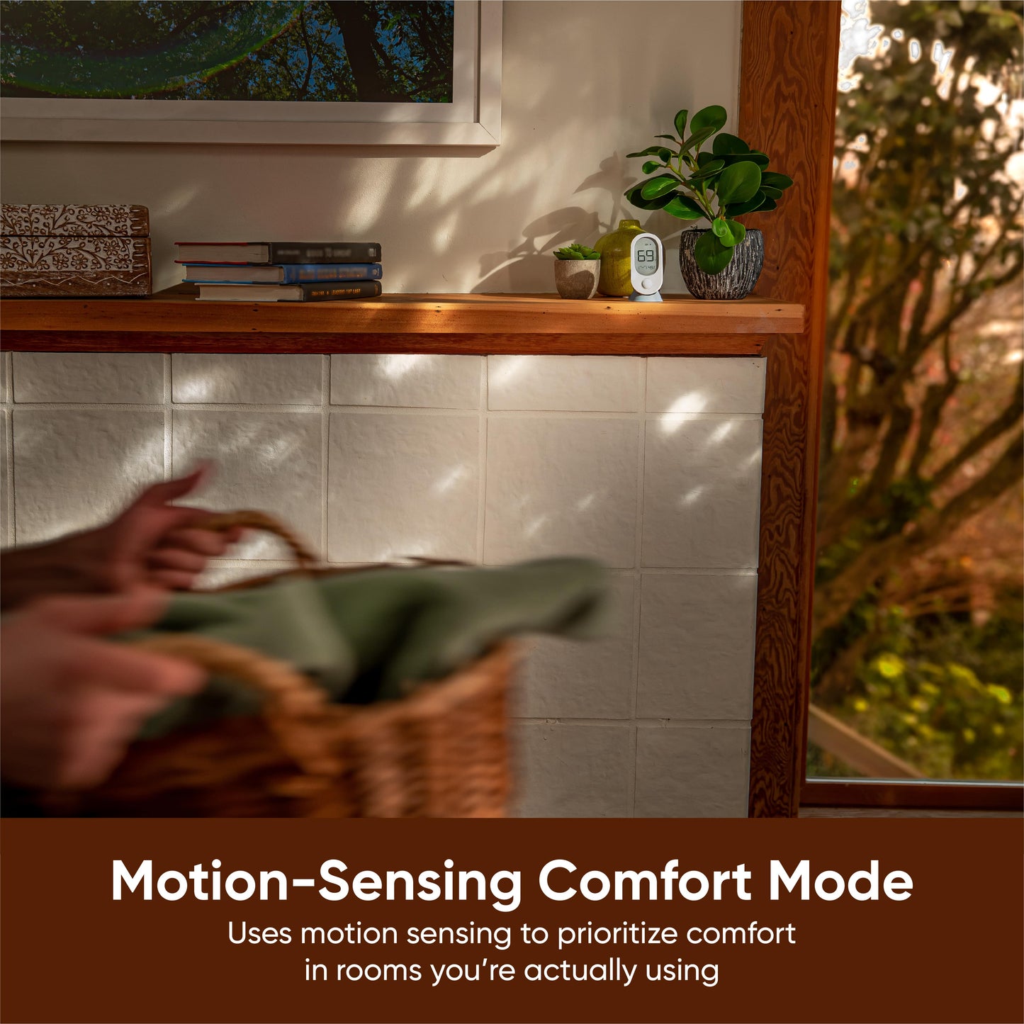Room sensor on a stand sitting on top of a shelf. White text overlay that says "Motion-Sensing Comfort Mode."