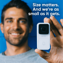 A man holding a white Wyze Video Doorbell.