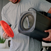 A man holding a Wyze Air Filter.