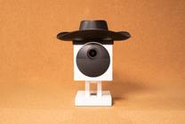 Wyze Cam Outdoor Cowboy Hat - A black and white camera with a cowboy hat on top.