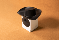 A black and white cowboy hat with a camera attached to it.