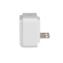A white power cord plugged into a wall outlet.
