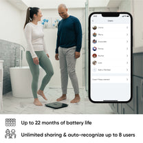 A black and white Wyze Scale X is shown with a man and woman standing next to it.