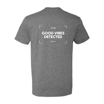 A grey shirt with the words "Wyze Shirt - Good Vibes Detected" written on it.