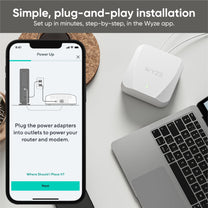 A Wyze Wi-Fi 6 Mesh Router displayed on a table.